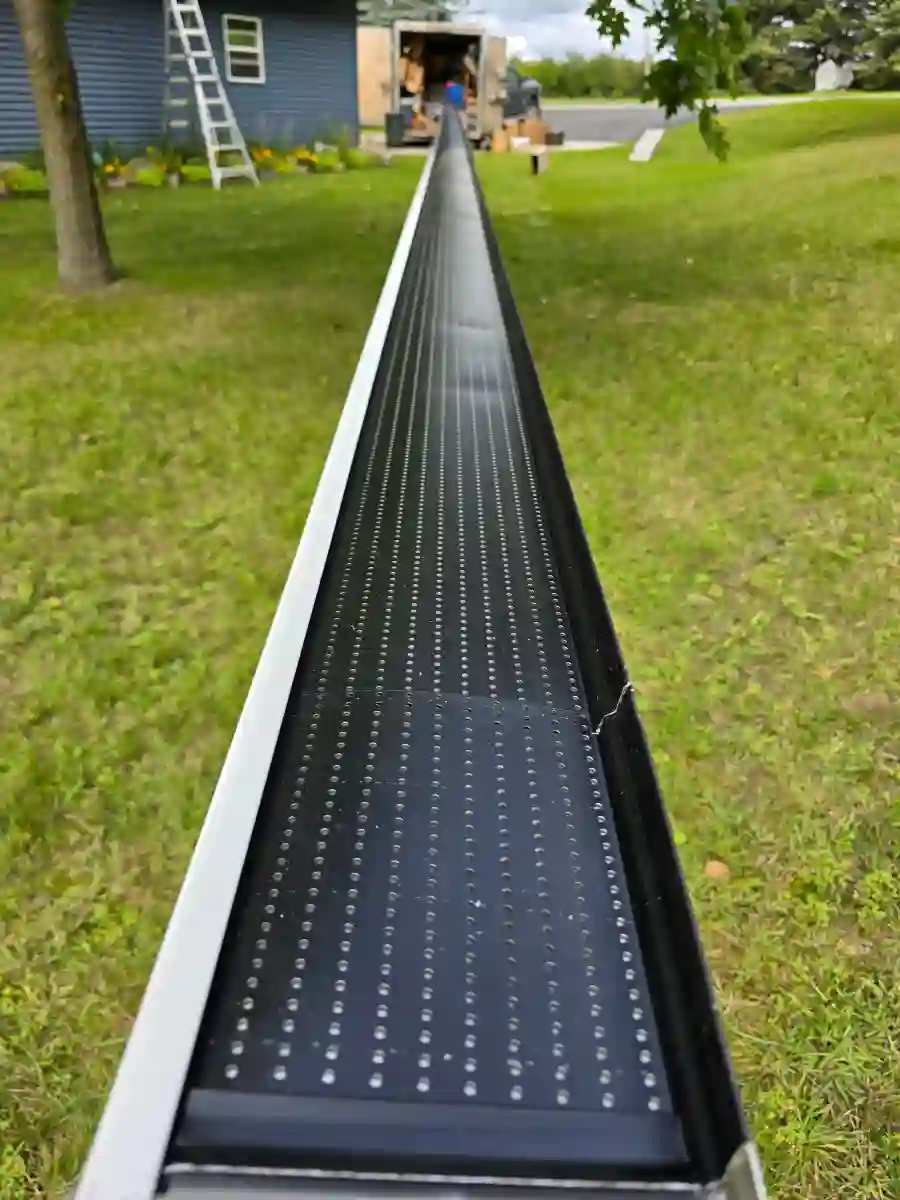 Black gutter guard mesh installed on a gutter