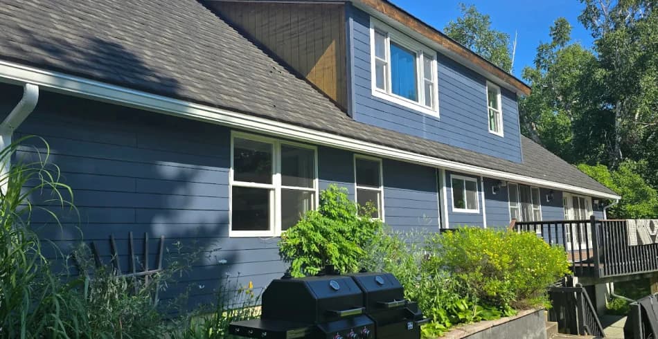 Blue lap siding on a two-story Northern Michigan home with white trim